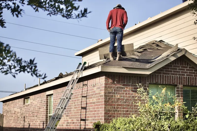 Professional roofer working on a residential roof in Denville